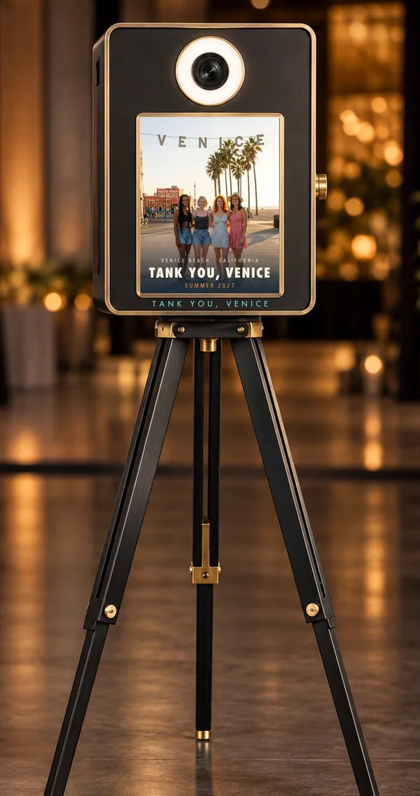 The same booth showing four friends under the VENICE sign, with Tank You, Venice lettered under the screen
